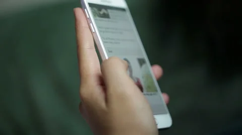 Woman use mobile device while relaxing on a sofa. Stock Footage 64050635