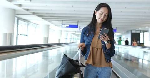 Woman use of mobile phone in airport Stock Footage