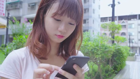 Woman use of mobile phone in the city Stock Footage