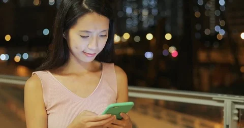 Woman use of mobile phone in the evening Stock Footage