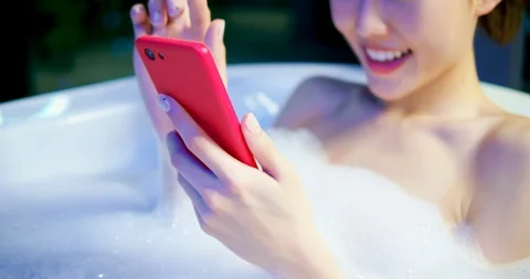 Woman use smartphone while bathing Stock Footage 106833980