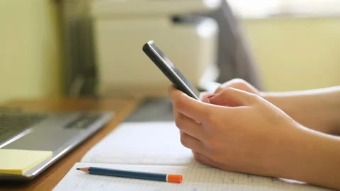 Woman use smartphone while studying at home,social network tech addiction Stock Footage 151610886