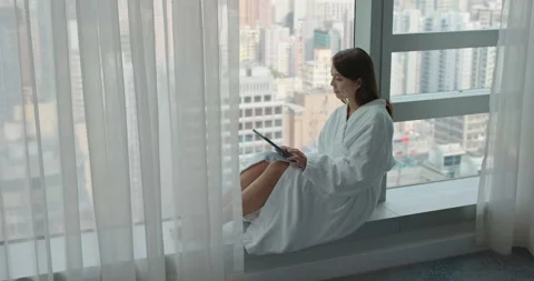 Woman use tablet computer and sit beside window Stock Footage 139145932