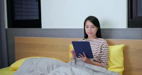 Woman use tablet computer on bed Stock Footage 290825908