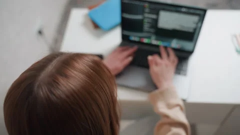 Woman uses laptop to write scripts. Caucasian woman concentrates while Stock-Footage 336866881