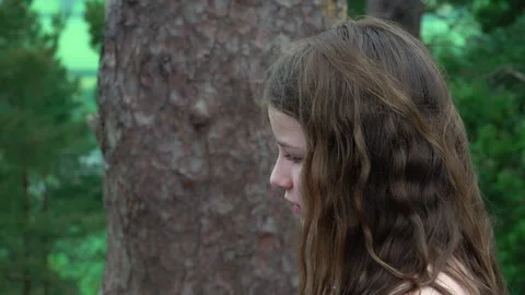 A woman uses a phone while out in a woodland Stock Footage 132737853