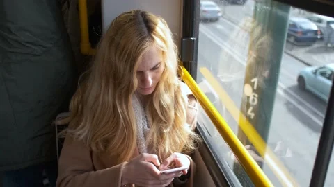 Woman uses a smartphone while sitting in a tram Video stock 144250126