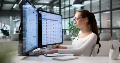 Woman Uses Software On Computer To Organize Office Digital Files Today. Stock Photos