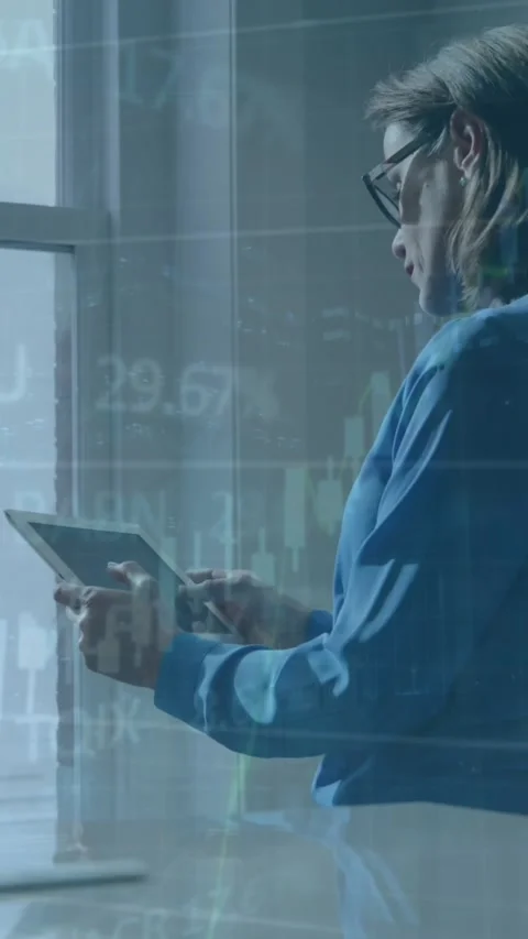 A woman uses a tablet computer in an office Stock Footage 343779573