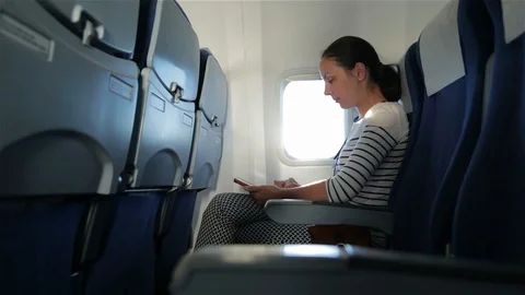 Woman uses tablet computer touchscreen in the plane Vídeos de archivo 98121862