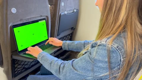 A woman uses a tablet or e-book in a modern tram, bus or subway. A beautiful Stock-Footage 253174774