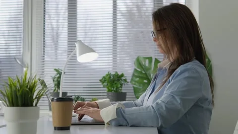 A woman uses technology to create a harmonious virtual classroom. She conducts Stock Footage 260605084