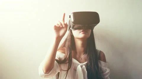 Woman uses a virtual reality glasses Stock Footage