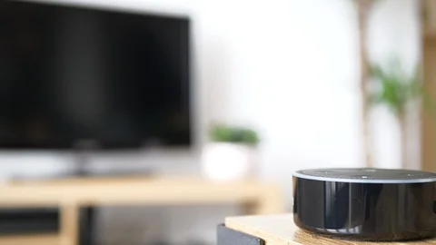 Woman Uses Voice Command With Smart Home Device To Turn On TV Video stock 126907565