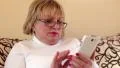 Woman uses white smartphone. Female with smartphone HD Footage