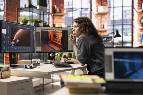 Woman using AI chatbot interface to generate video game spaceship environments 스톡 사진