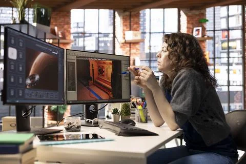 Woman using AI chatbot interface to generate video game spaceship environments Stock Photos