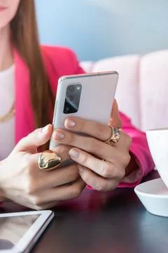 Woman using app on phone to communicate at cafe, Close-up of her hands. Lif.. Stock Photos