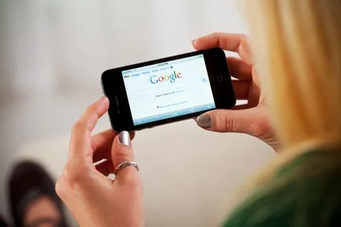 Woman Using Apple iPhone 4 To Access Google Website Stock Photos