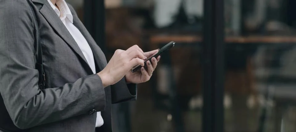 Woman using apps on a mobile touchscreen smartphone. Concept for using Stock Photos