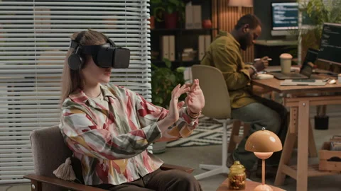 Woman Using AR Goggles when Male Colleague Developing on Computer at Office Video stock 302893672