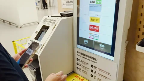 Woman Using Automated Machine and Smartphone in Building Stock Footage 293468950