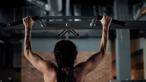 Woman using bar to do chin ups  Video stock 73695476