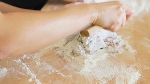Woman using bench scraper to mix beet flour into pasta dough Stock Footage 199152591