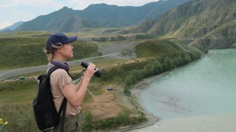 Woman using binoculars while hiking in mountains. Stock Footage 301592487