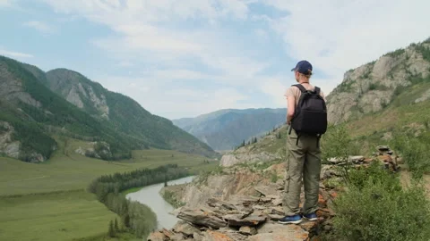 Woman using binoculars while hiking in mountains. Stock Footage 301593735