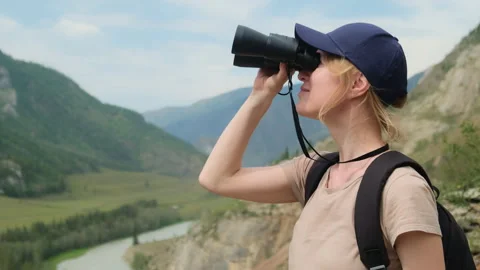 Woman using binoculars while hiking in mountains. Stock Footage 301593755
