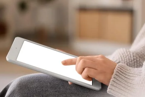 Woman using blank tablet computer at home, closeup 스톡 사진