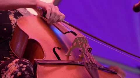 Woman using the bow and playing the cello Stock Footage 56964499