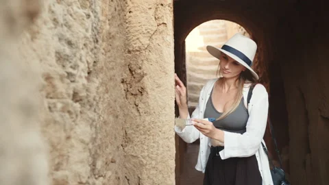 Woman using brush while digging ruined ancient temple Stock Footage 166565181