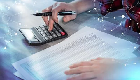 Woman using calculator; light effect Stock Photos