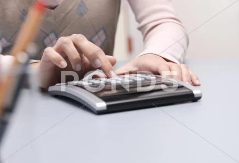 Woman Using Calculator, Mid-Section