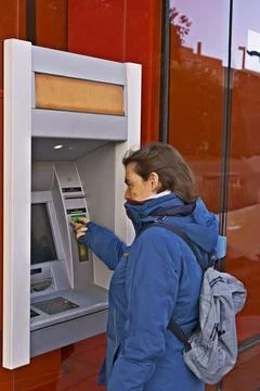 A woman is using a card reader to pay for something Stock Photos