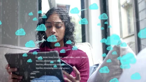 Woman using card on tablet causing teal cloud-code overlay building then fading Stock Footage 333657148