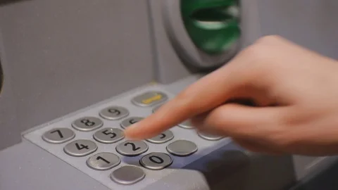 Woman using cash machine. Female hand entering pin code on the ATM keypad. Stock Footage