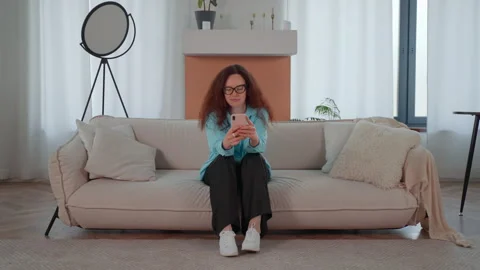 Woman Using Cell Phone on Couch Stock Footage 266781833