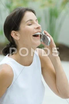 Woman Using Cell Phone, Laughing, Eyes Closed