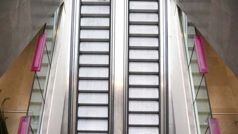 Woman using cell phone while riding down escalator Stock Footage 75192702