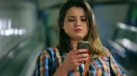 Woman using cellphone while riding on escalator, steadycam shot Vídeos de archivo 43120494