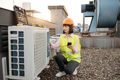Woman using checking tool for work with air conditioner Stock Photos