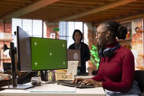 Woman using chroma key computer to develop AI systems Stock Photos