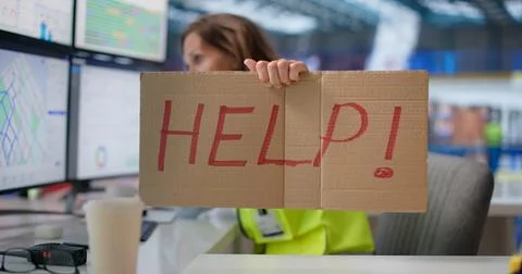 Woman Using Computer In Busy Warehouse Managing Automation System Pressure. Fotos Stock