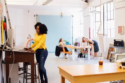 Woman using computer in creative studio 스톡 사진