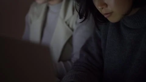 A woman using a computer in the dark Stock Footage 332578534