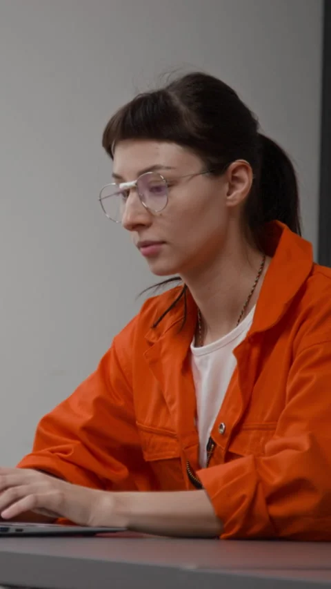 Woman Using Computer at Desk in Correctional Facility Vertical Stock Footage 329002927