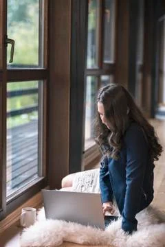 Woman using a computer on the floor Stock Photos